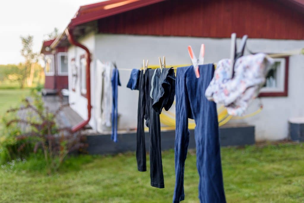 clothes hanging on a line to dry outside to prevent mold damage in the home
